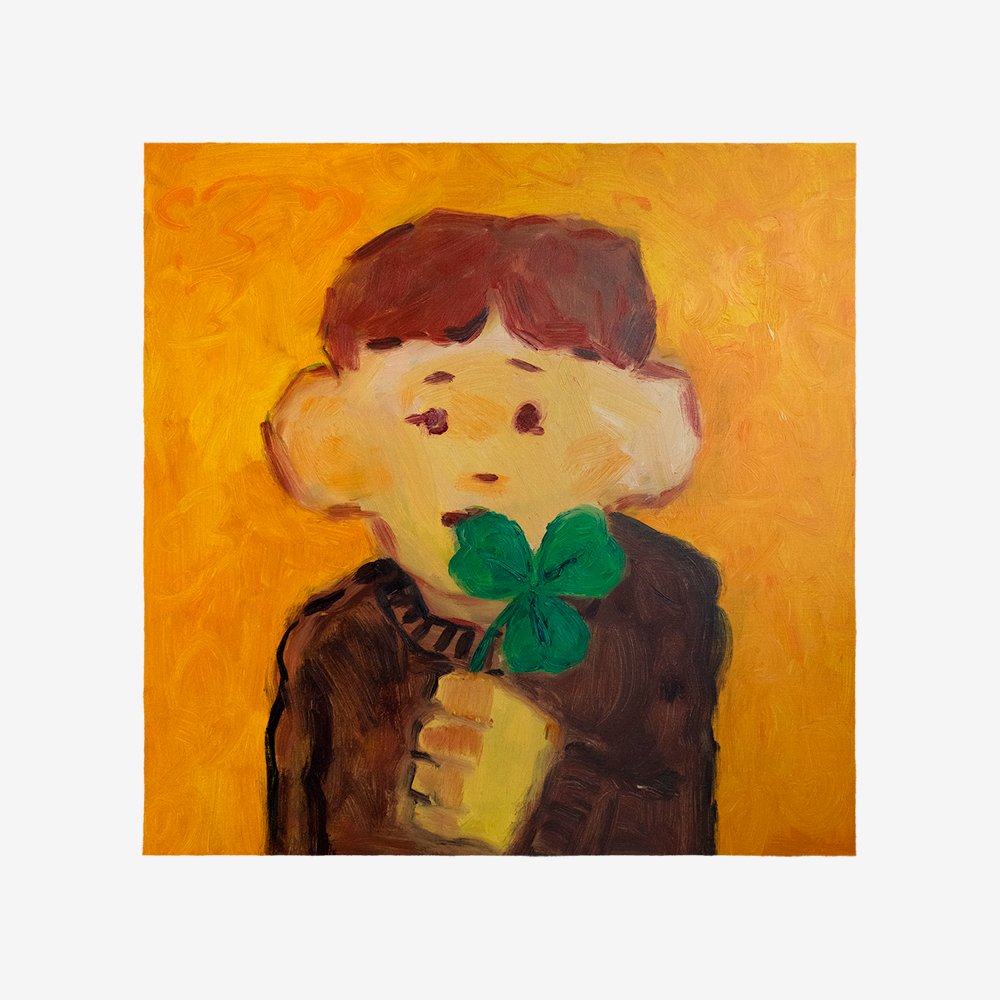 boy holding a three leaf clover