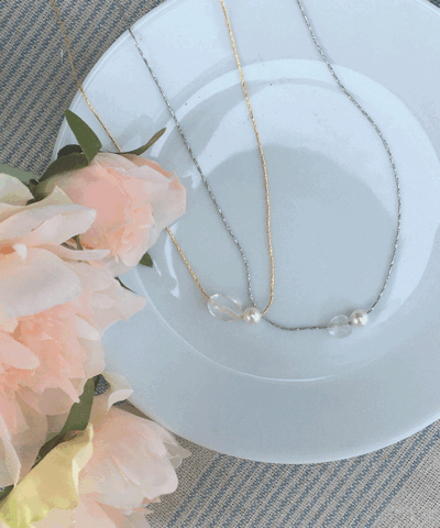 Cince transparent ball and pearl necklace.